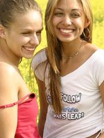 sweet teens naked and licking pussy in a field of flowers